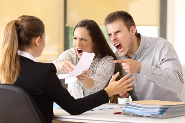 Angry couple claiming and shouting to an office worker