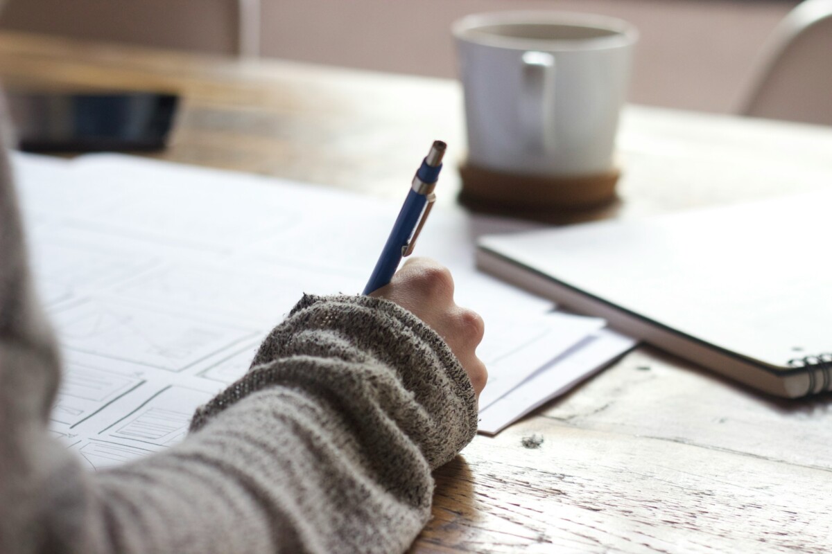 person writing to make a plan for marketing strategies